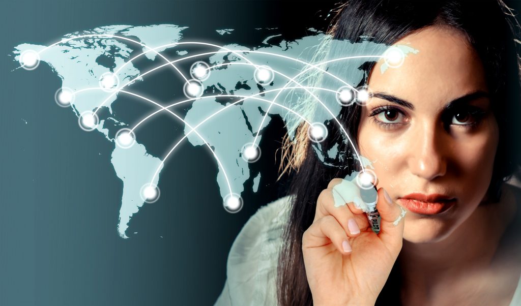 Woman drawing a network over a virtual world map